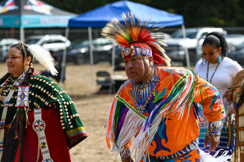 Participants in the powwow dressed in full traditional regalia.