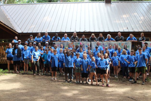 Dozens of campers and counselors pose for a group photo at KUBI camp. 
