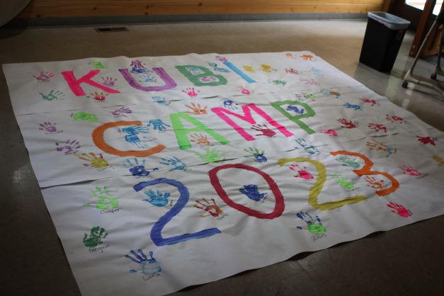 A KUBI Camp sign made by campers.