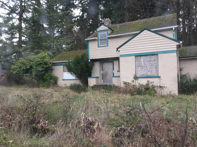 tan house with green trim assigned for a correctional officer.