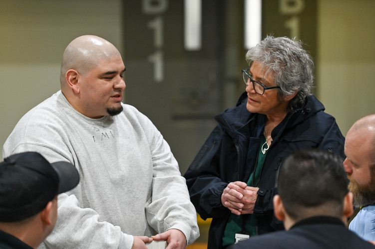 Cheryl Strange, DOC Secretary having a conversation with resident