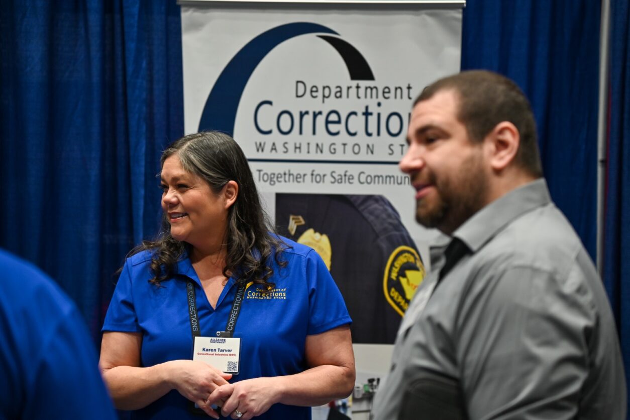 two people listening to vendor speak