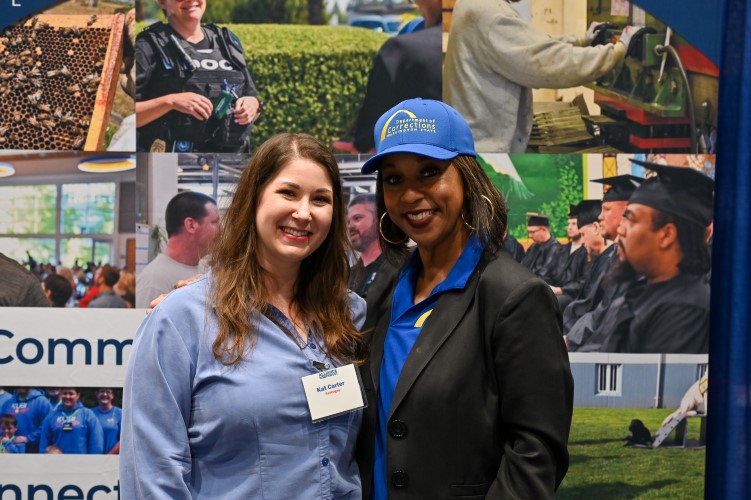 two people standing side by side at vendor event