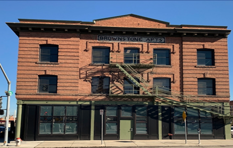 image of the red brick three story apartment looking Brownstone Reentry Center.