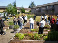 image of the outside of the everett community justice center with people near garden beds