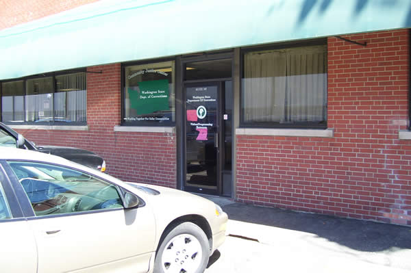 image of the outside of the red brick and green roof spokane community justice center front door