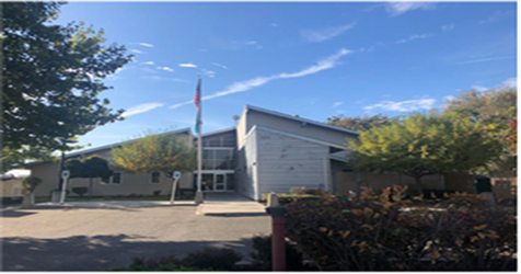 image of the Tri-Cities Reentry Center with American Flag out front.