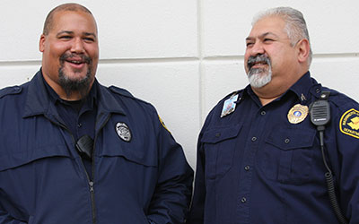 two male correctional officers laughing together