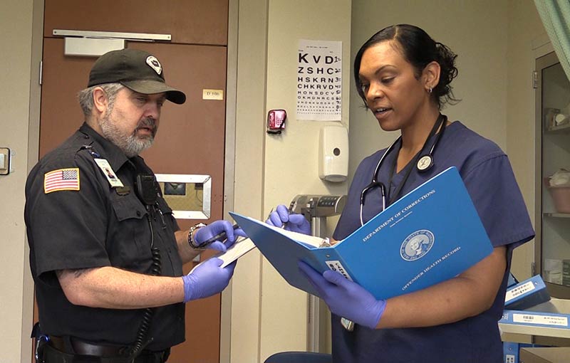 Correctional Officer and Nurse working together sharing notes