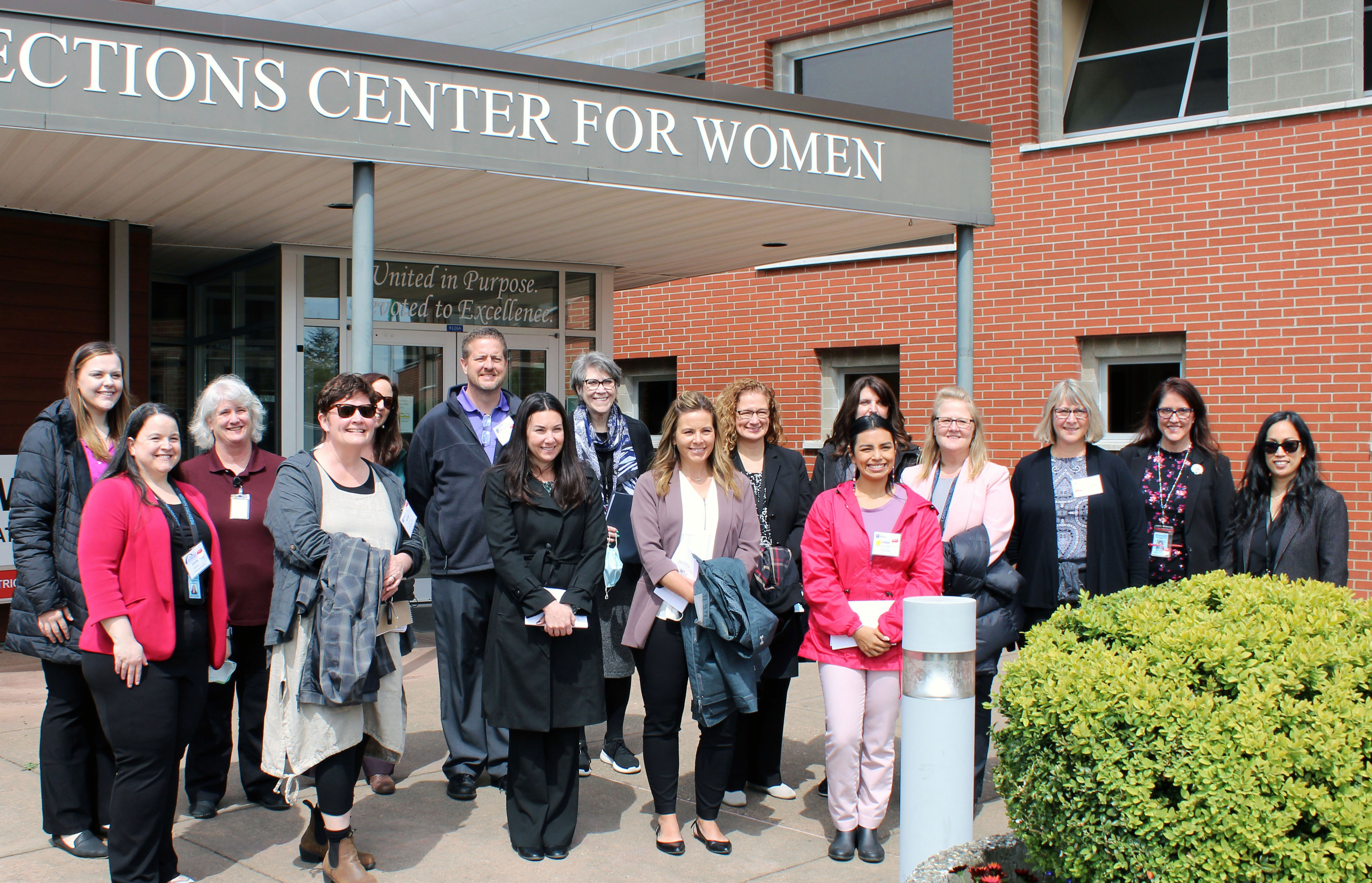 A group of people from New York University, the Illinois Department of Corrections and the Washington Department of Corrections stand outside the Washington Corrections Center for Women after the group toured the facility.