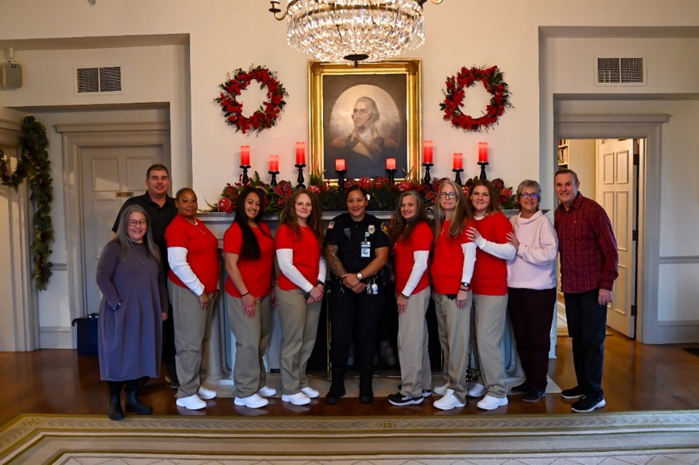 Incarcerated individuals join Secretary Cheryl Strange for a photo at the Gov. Mansion decorating event in Olympia, WA.