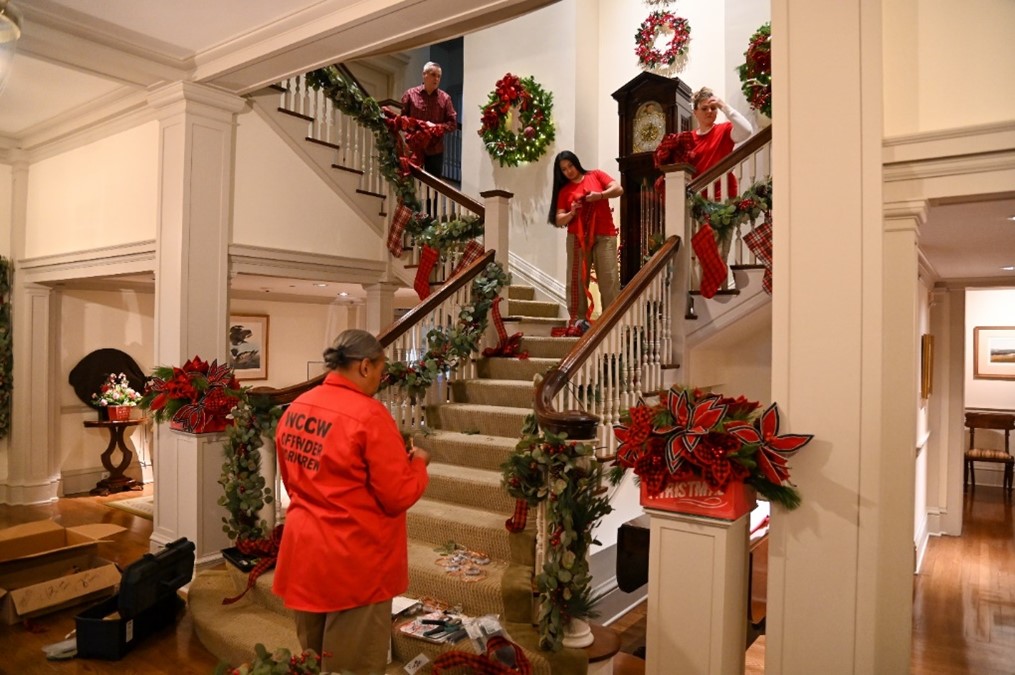 Incarcerated individuals decorate a stairwell at the Gov. Mansion.