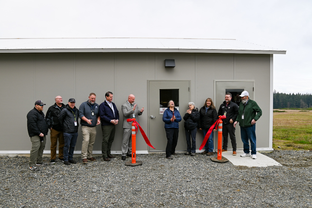 Group of people standing in front of a small building