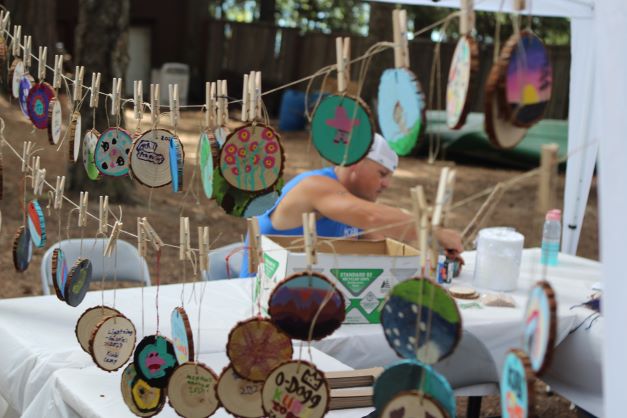 Arts and crafts created by campers hanging and pinned up by clothes pins. 