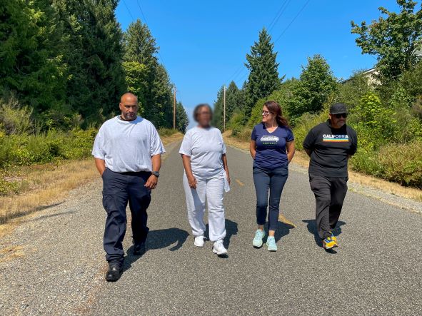 Outing group walks along trail.