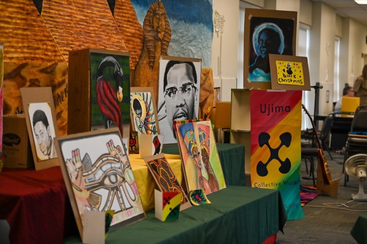 Pieces of art representing black history month on a table.