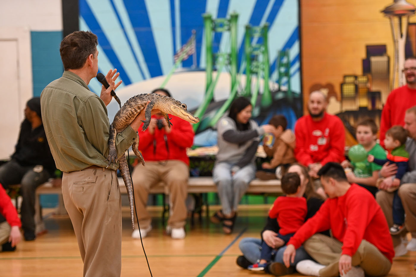 Families enjoying wildlife demostration of an alligator