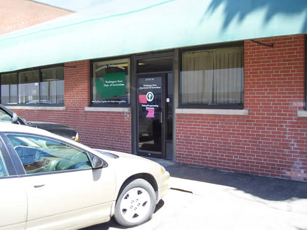 image of the outside of the red brick and green roof spokane community justice center front door